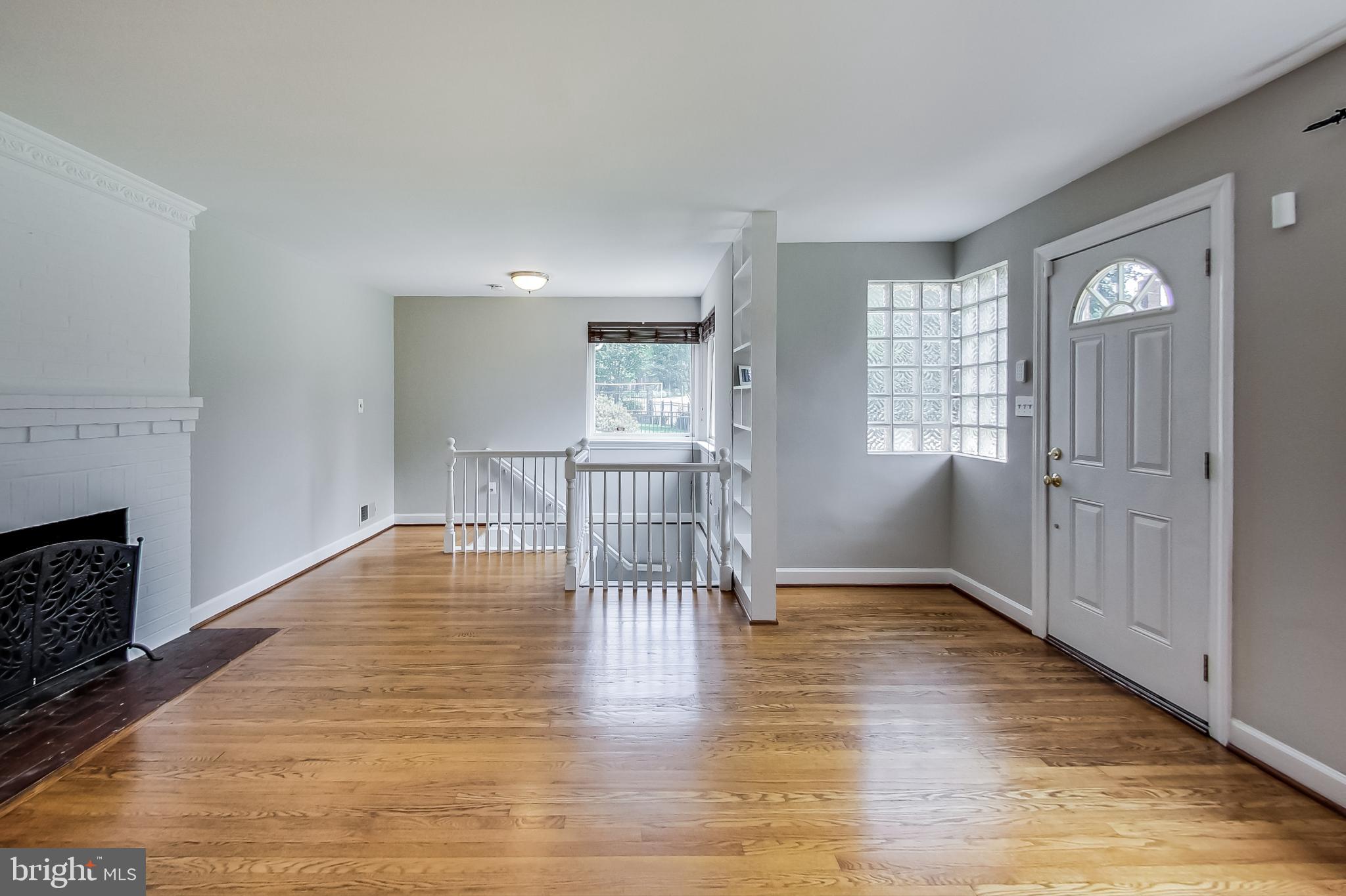 8617 Lynbrook Drive Bethesda, MD 20814 - Photo 9 of 48 a view of empty room with wooden floor and fireplace