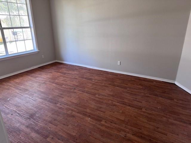 834 Graham Street Paris, TX 75460 - Photo 4 of 8 an empty room with wooden floor and windows