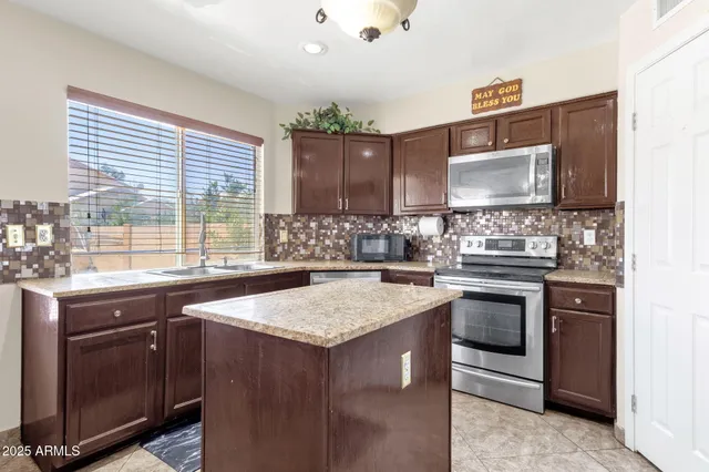 a kitchen with center island and sink