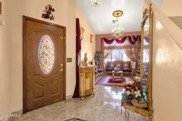 a living room with furniture a rug and a chandelier