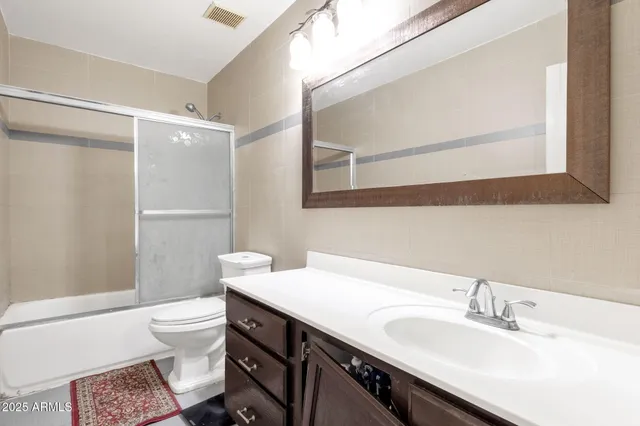 a bedroom with 2 bed and a chandelier