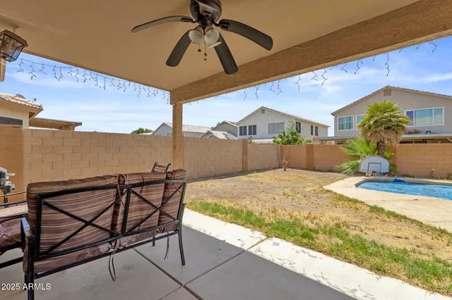 a view of a patio with table and chairs and floor to ceiling window
