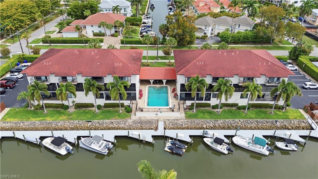 1400 Blue Point Avenue, Unit 206 Naples, FL 34102 - Photo 1 of 19 a view of house with pool and a yard