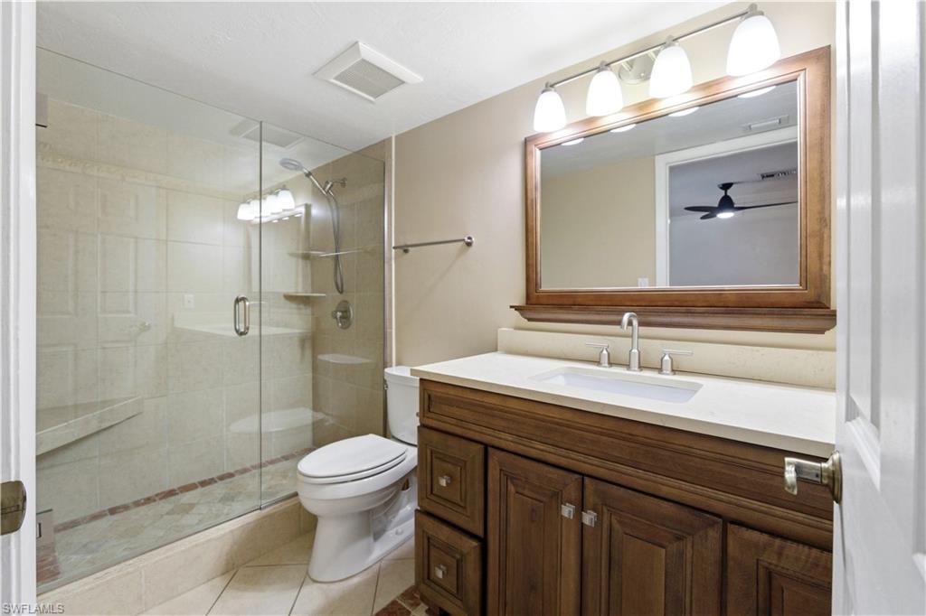 1400 Blue Point Avenue, Unit 206 Naples, FL 34102 - Photo 11 of 19 a bathroom with a sink a toilet and shower