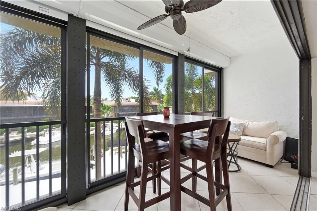 1400 Blue Point Avenue, Unit 206 Naples, FL 34102 - Photo 14 of 19 a view of a dining room with furniture window and outside view