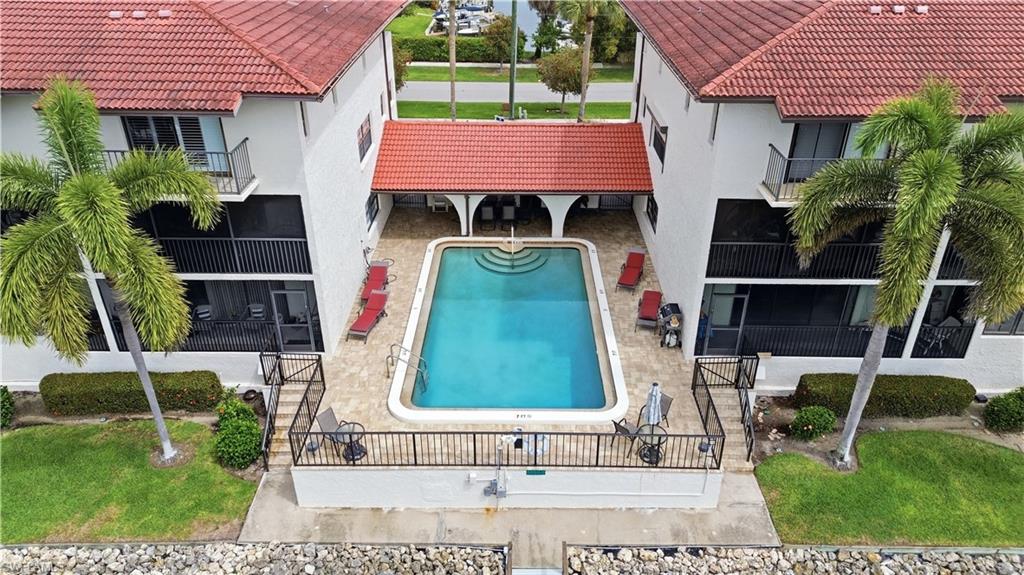 1400 Blue Point Avenue, Unit 206 Naples, FL 34102 - Photo 17 of 19 a front view of house with a garden