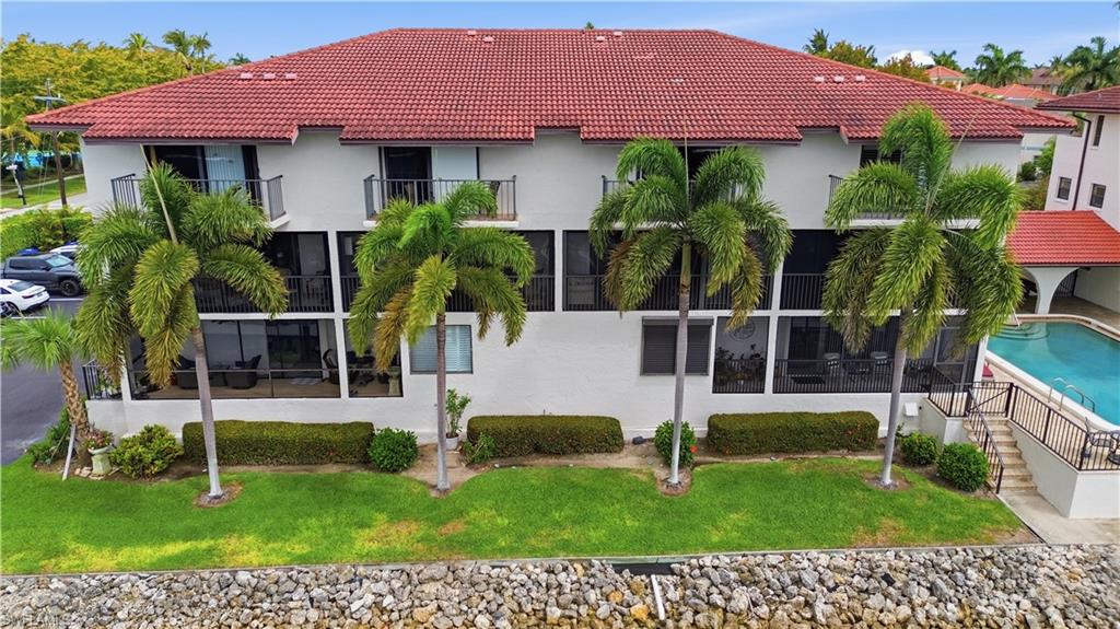 1400 Blue Point Avenue, Unit 206 Naples, FL 34102 - Photo 19 of 19 a front view of a house with a yard