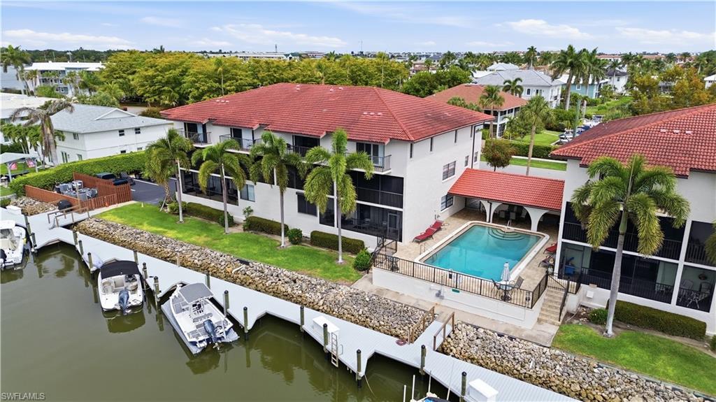 1400 Blue Point Avenue, Unit 206 Naples, FL 34102 - Photo 2 of 19 an aerial view of a house with swimming pool a patio and yard