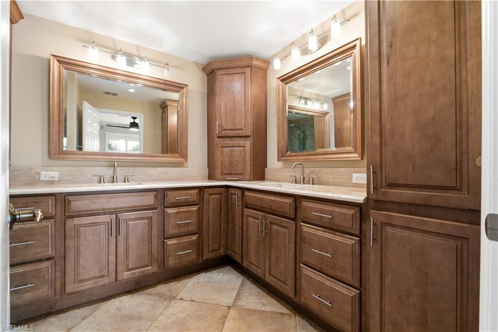 1400 Blue Point Avenue, Unit 206 Naples, FL 34102 - Photo 6 of 19 a bathroom with a double vanity sink and mirror