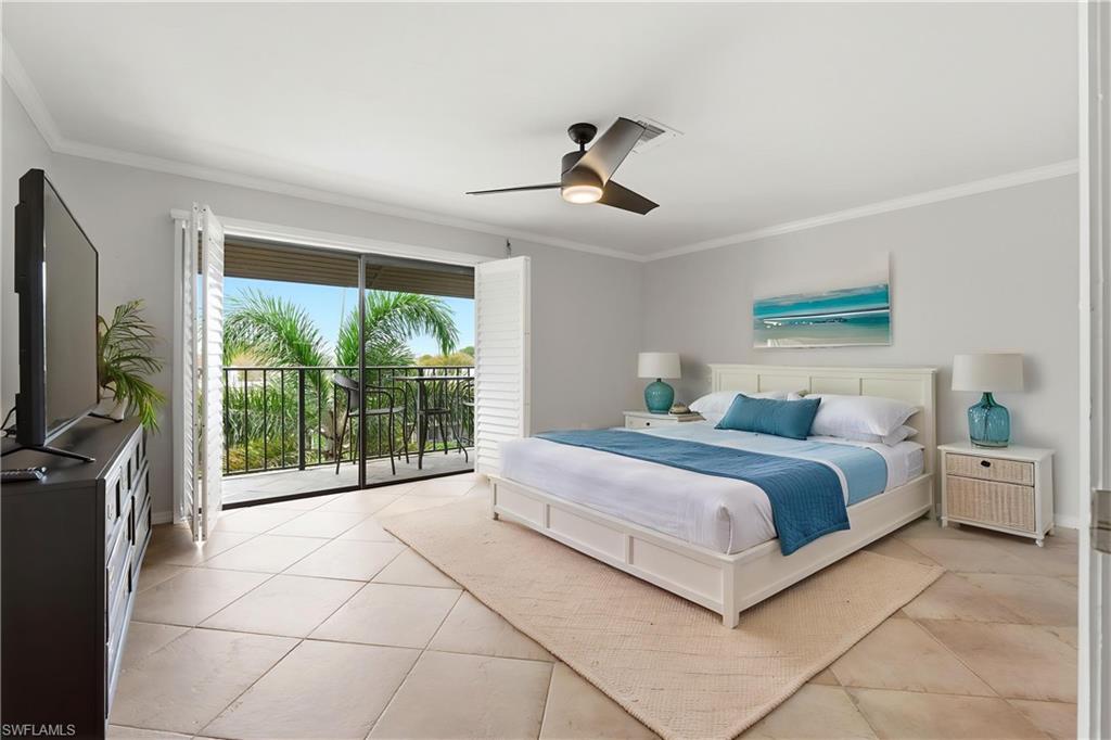 1400 Blue Point Avenue, Unit 206 Naples, FL 34102 - Photo 8 of 19 a bedroom with a balcony a bed and a television