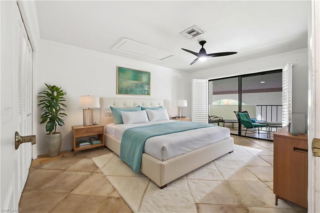 1400 Blue Point Avenue, Unit 206 Naples, FL 34102 - Photo 9 of 19 a bedroom with a large bed and a chandelier fan