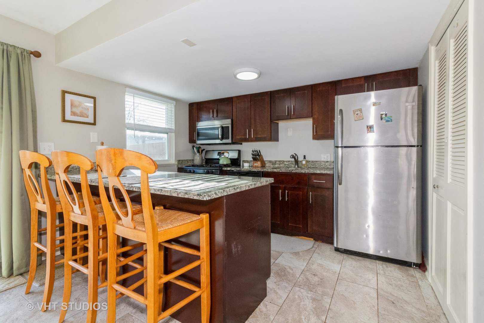 1939 Kenilworth Circle Hoffman Estates, IL 60169 - Photo 6 of 18 a kitchen with stainless steel appliances granite countertop a refrigerator and a stove top oven