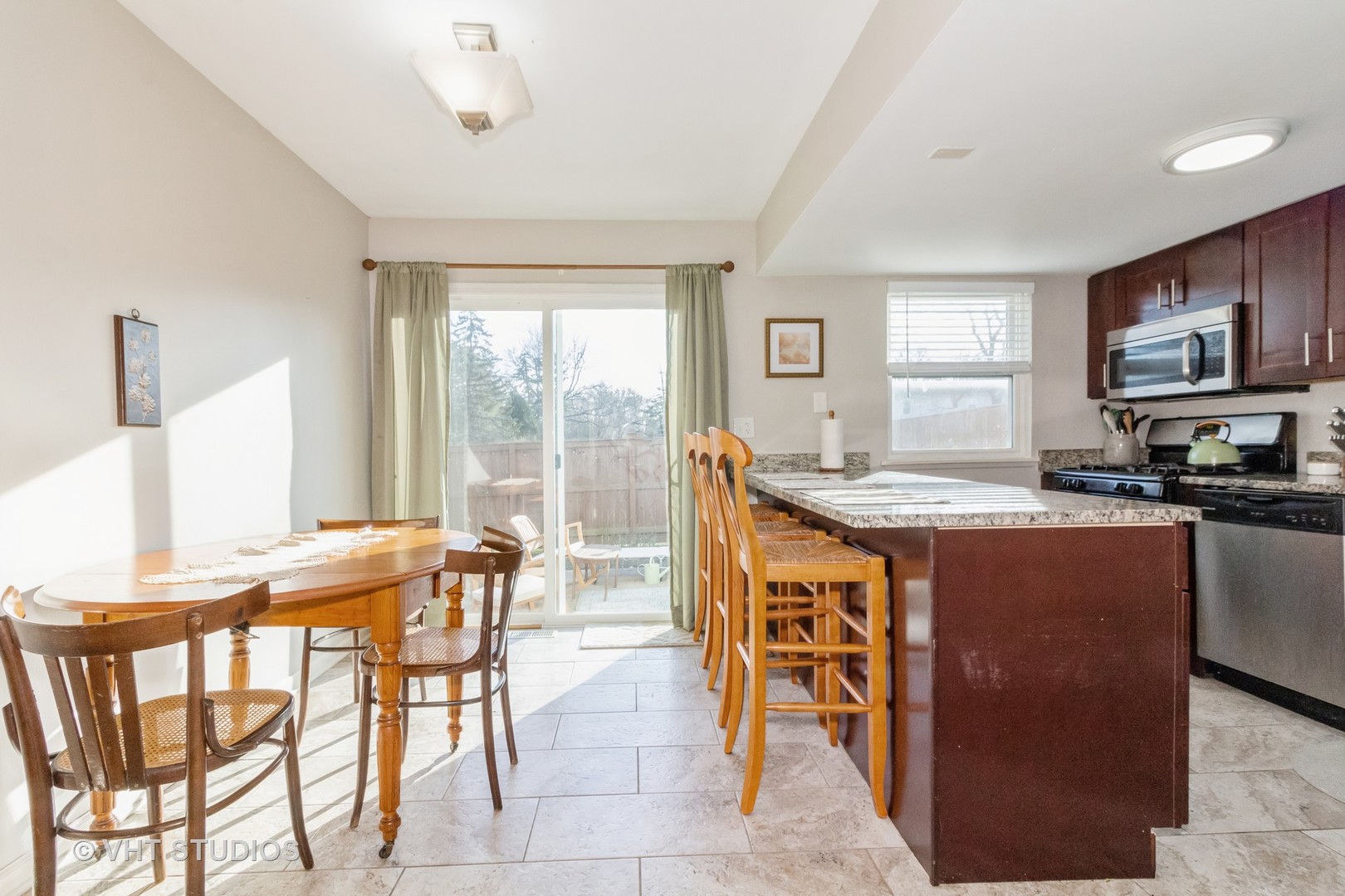 1939 Kenilworth Circle Hoffman Estates, IL 60169 - Photo 10 of 18 a dining hall with stainless steel appliances granite countertop a stove a sink a dining table and chairs