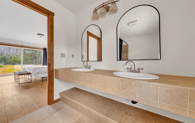 a bathroom with a tub a sink and a shower