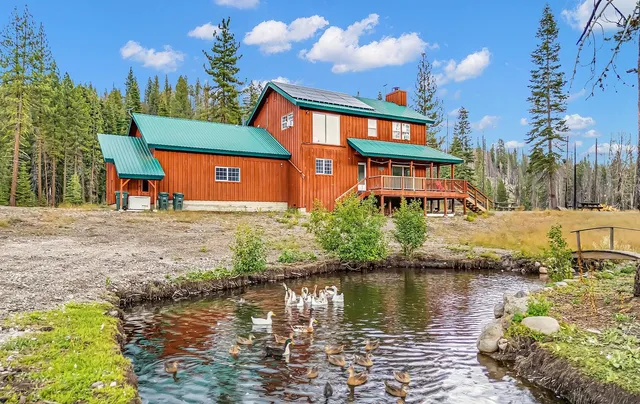 a front view of a house with a lake view