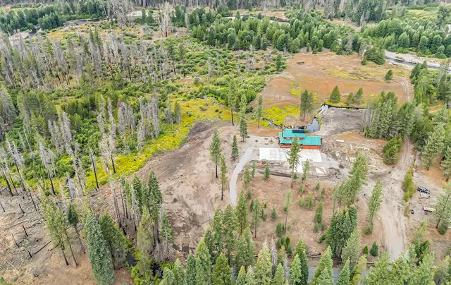 a view of swimming pool with lawn chairs and wooden fence