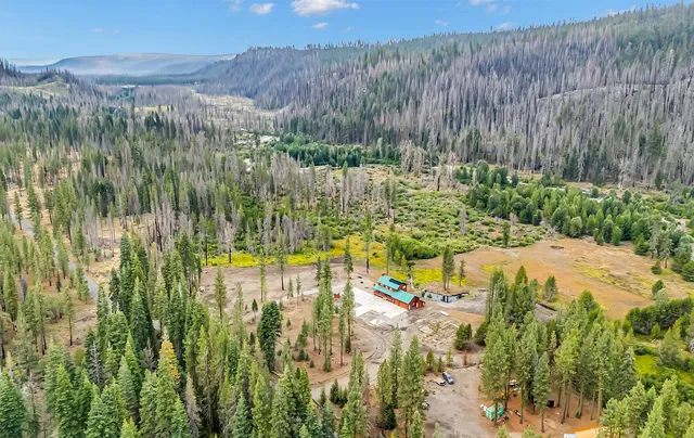 a view of backyard with swimming pool and seating space