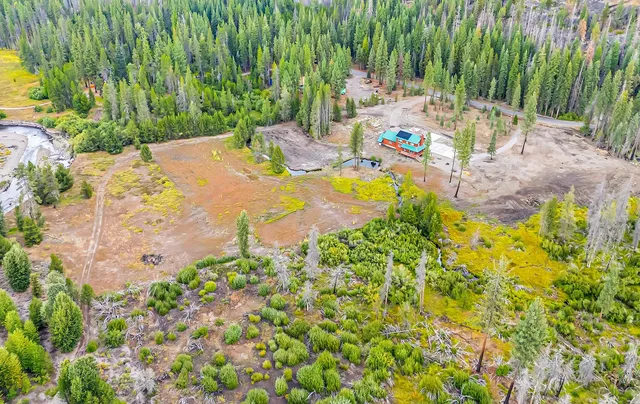 a backyard of a house with yard and outdoor seating