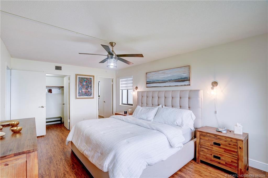 10 Northeast Plantation Road, Unit 101 Jensen Beach, FL 34957 - Photo 16 of 53 a bedroom with a bed and a tv