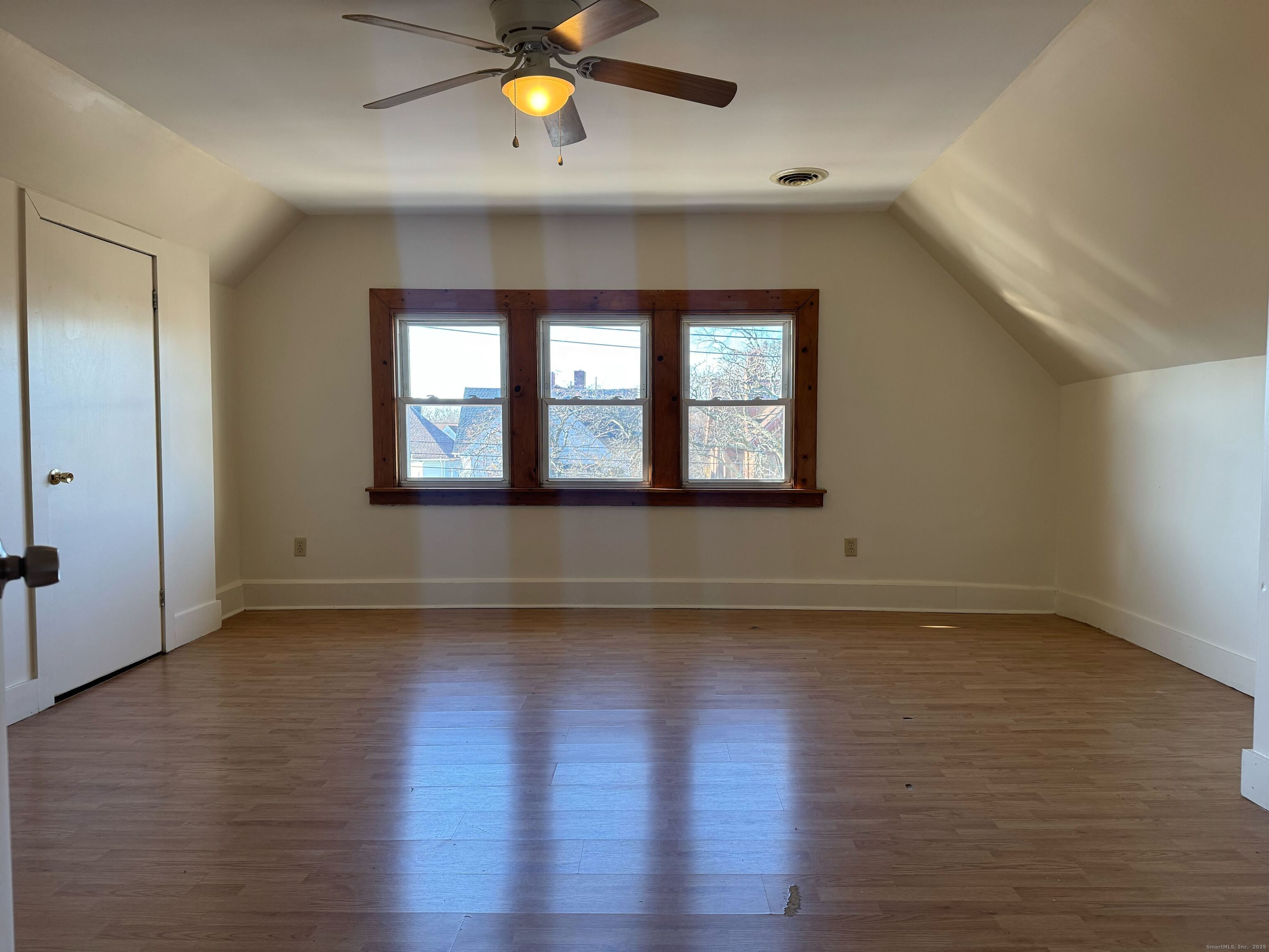 461 Howard Avenue, Unit 3 New Haven, CT 06519 - Photo 7 of 11 an empty room with wooden floor and windows