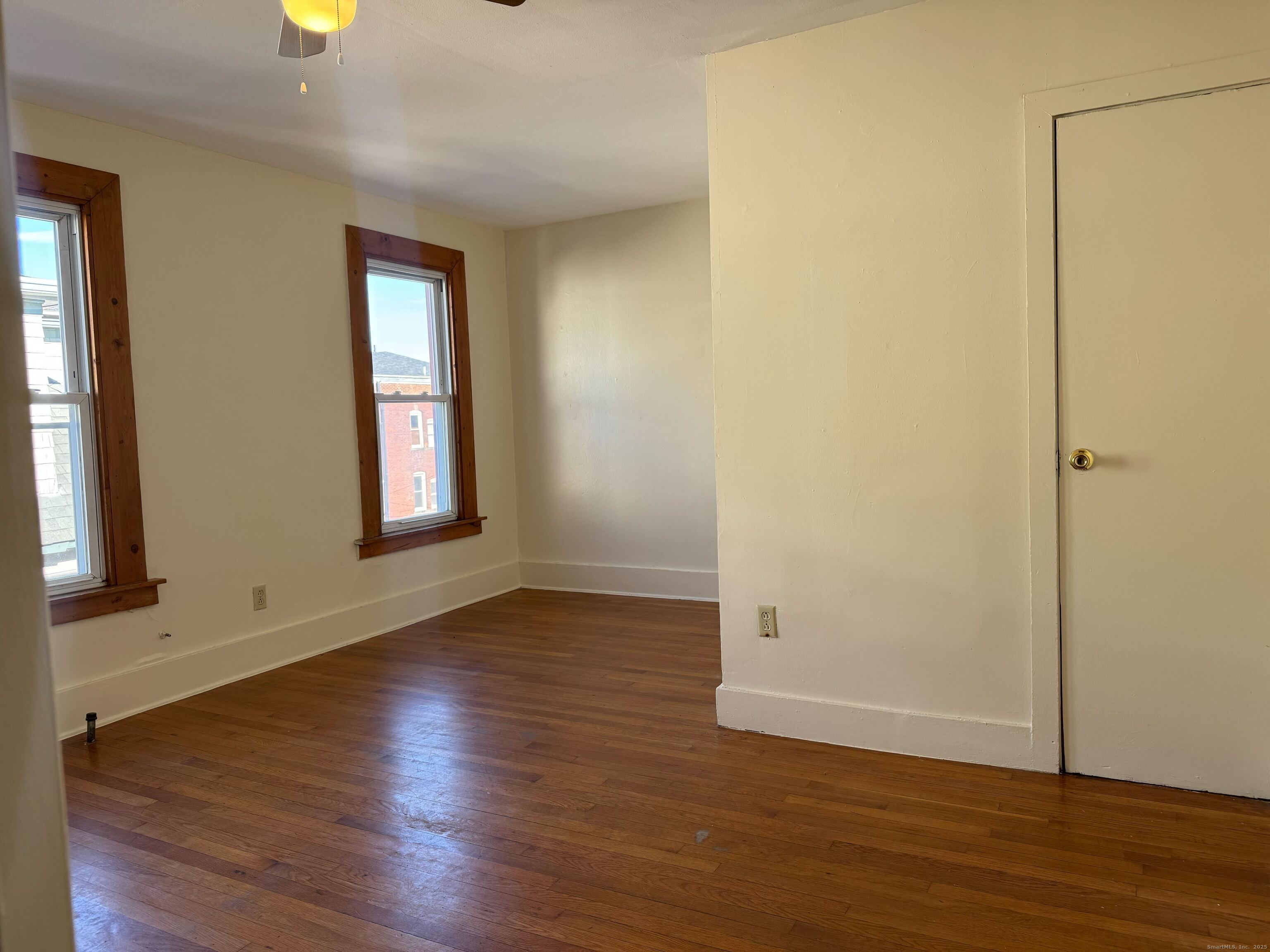 461 Howard Avenue, Unit 3 New Haven, CT 06519 - Photo 8 of 11 an empty room with wooden floor and windows