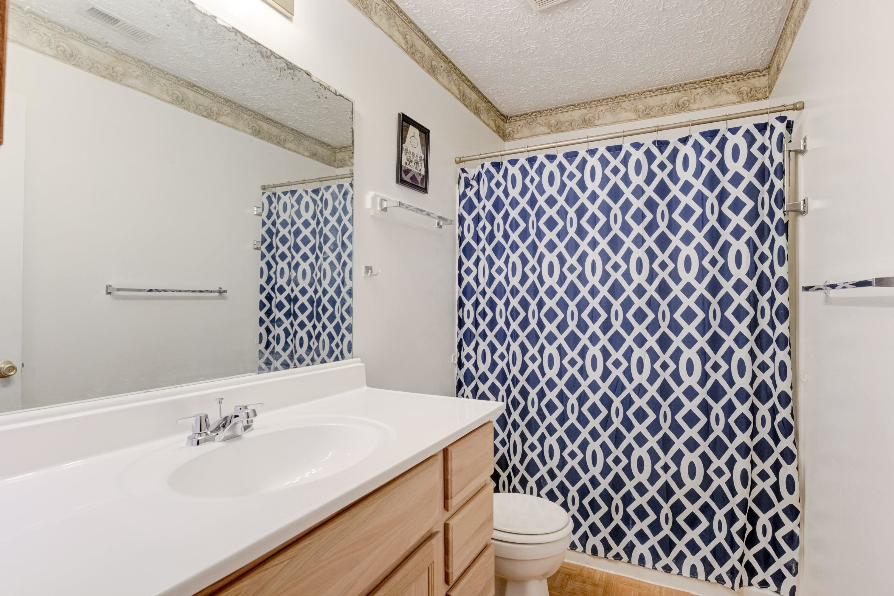 5823 Hadrian Drive Durham, NC 27703 - Photo 13 of 20 a bathroom with a sink and a toilet