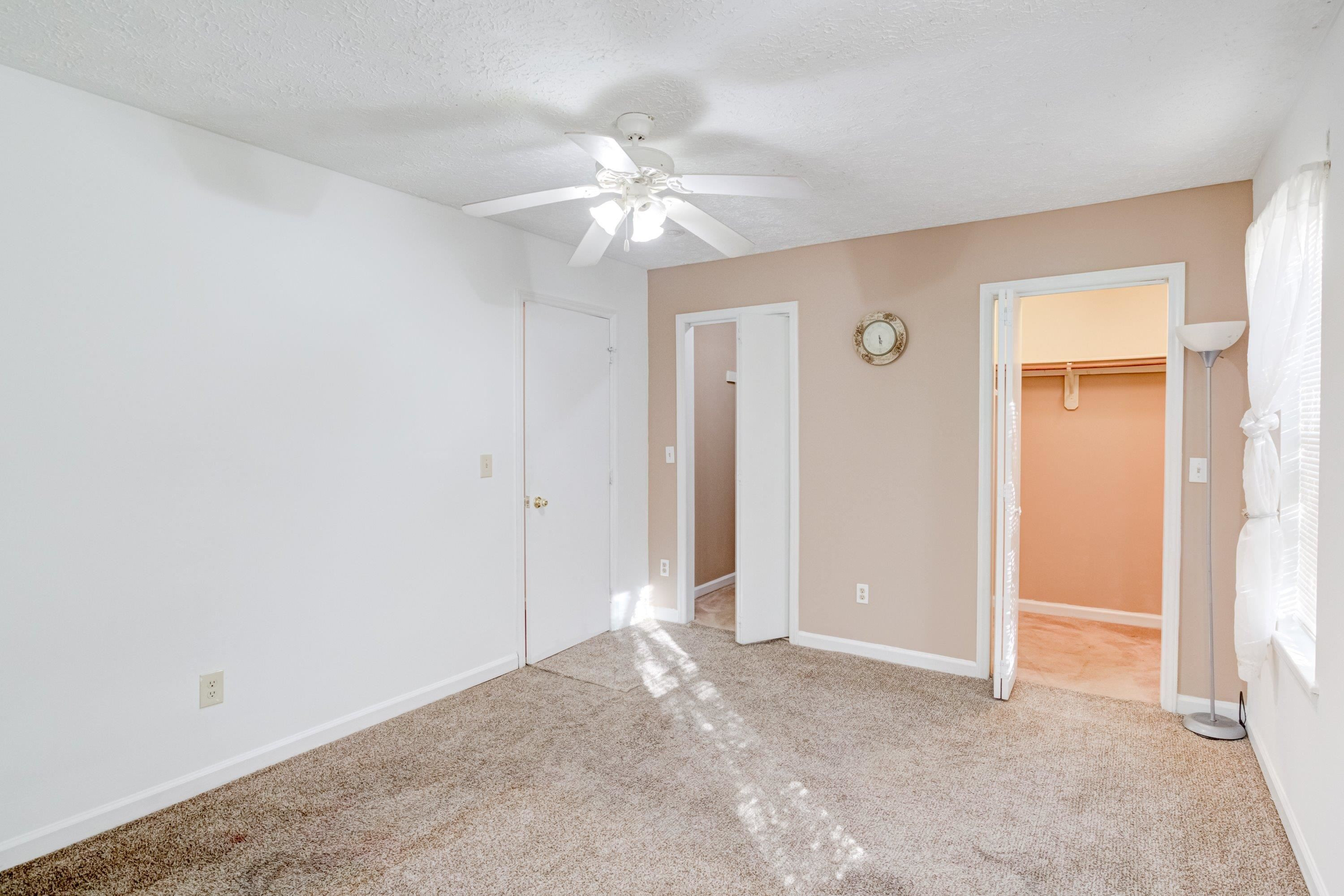 5823 Hadrian Drive Durham, NC 27703 - Photo 15 of 20 an empty room with closet and a chandelier fan
