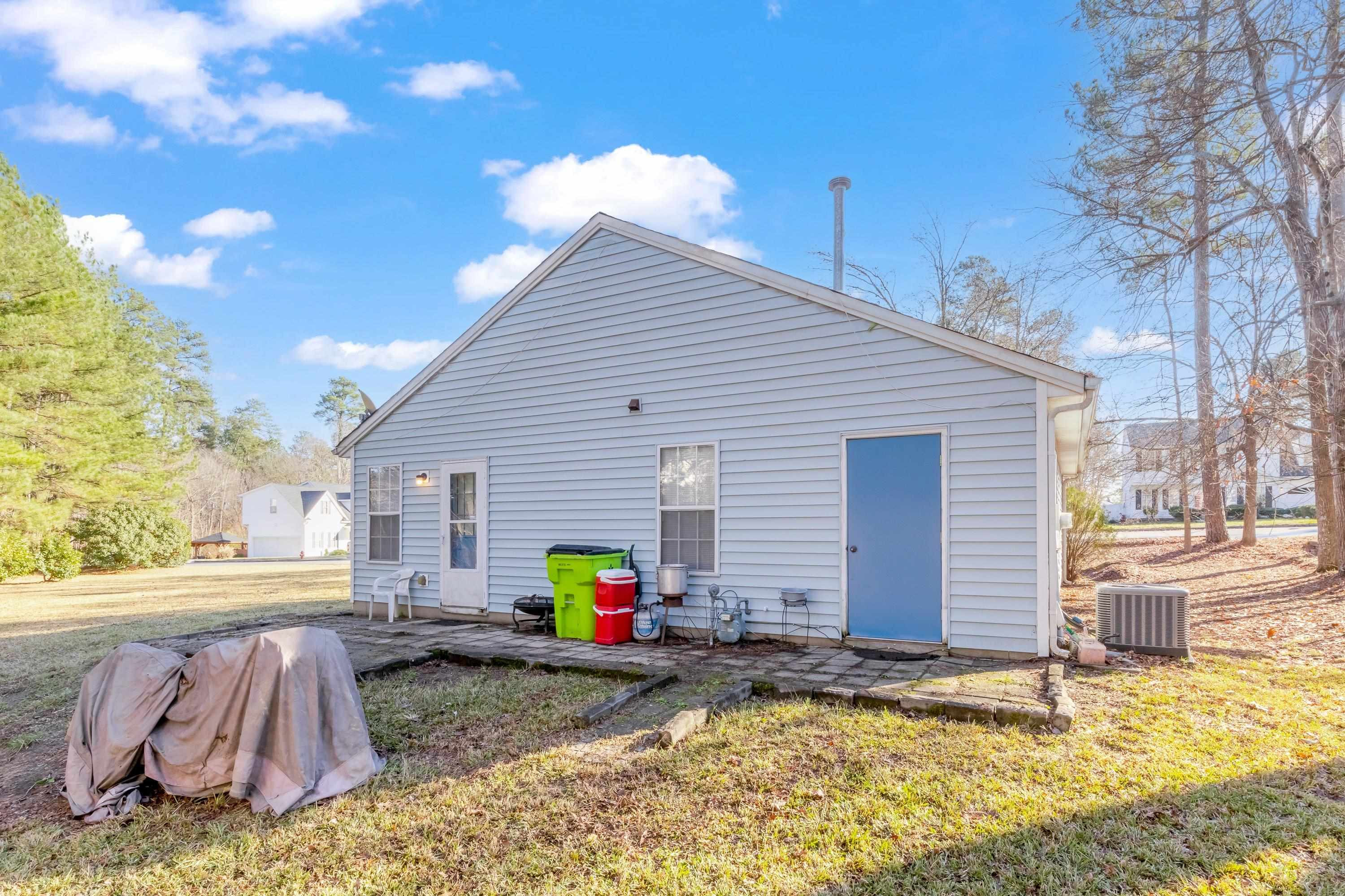 5823 Hadrian Drive Durham, NC 27703 - Photo 18 of 20 a front view of a house with yard patio and fire pit