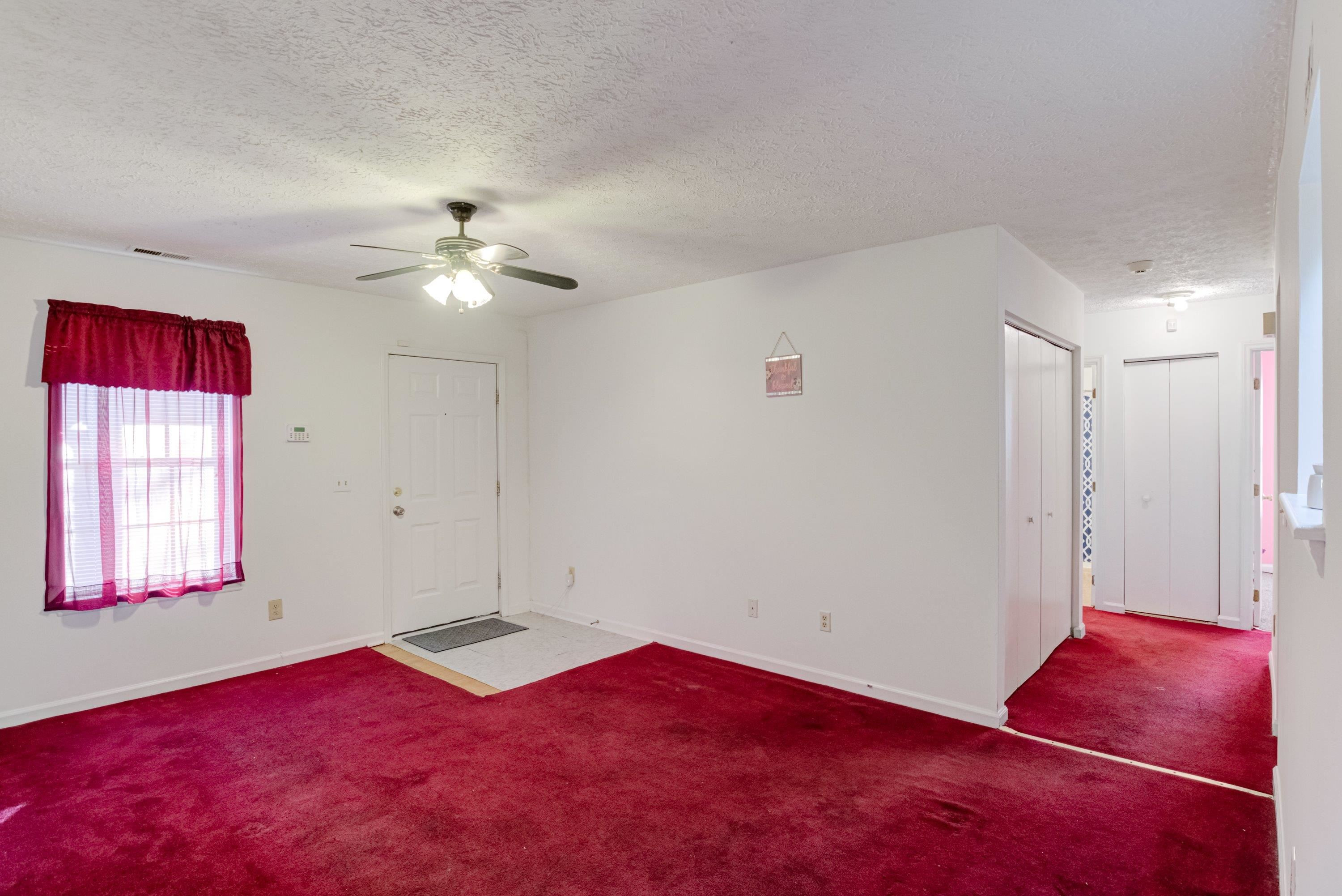 5823 Hadrian Drive Durham, NC 27703 - Photo 5 of 20 a view of empty room with window and ceiling fan