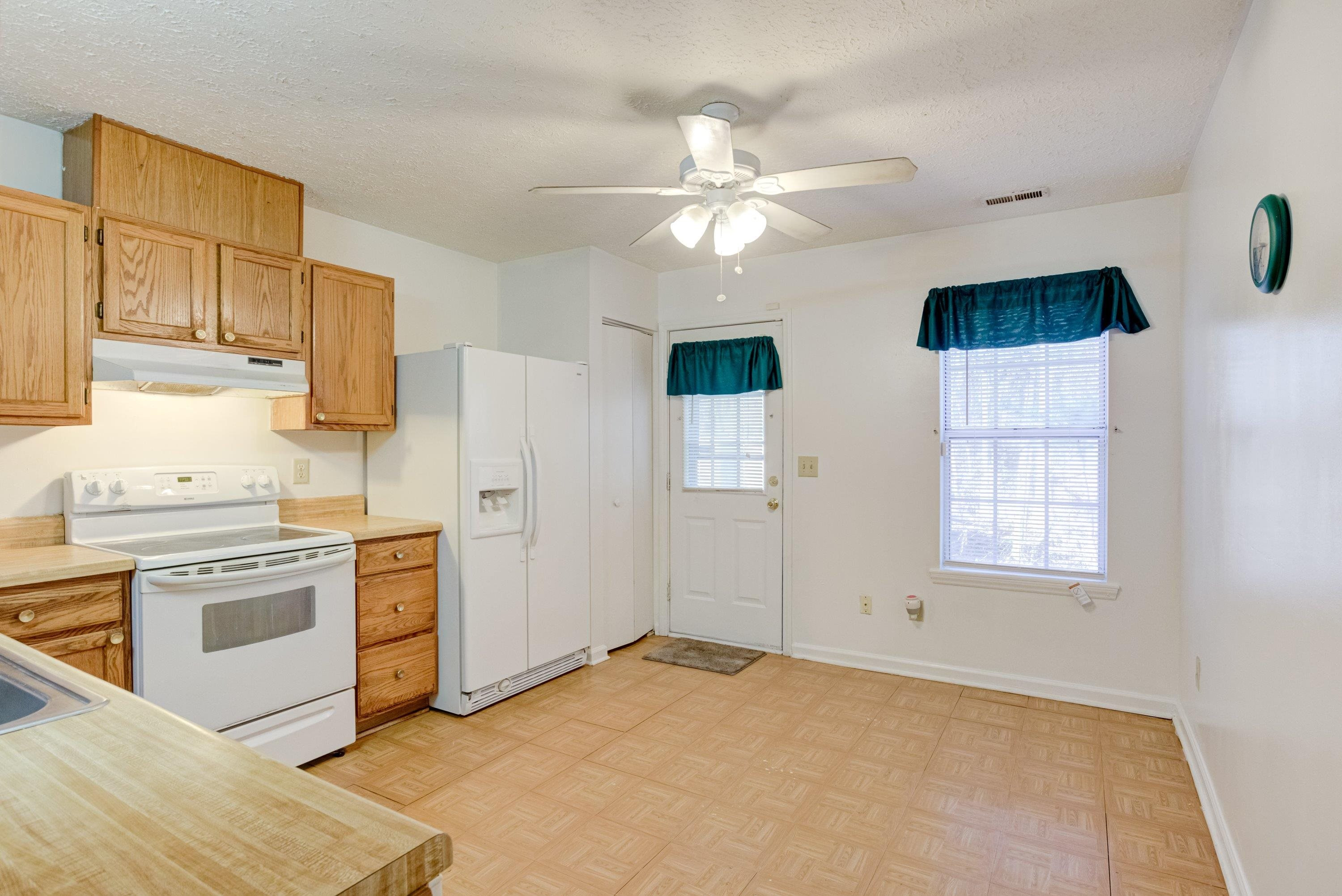 5823 Hadrian Drive Durham, NC 27703 - Photo 6 of 20 a kitchen with stainless steel appliances granite countertop a stove a sink and a refrigerator