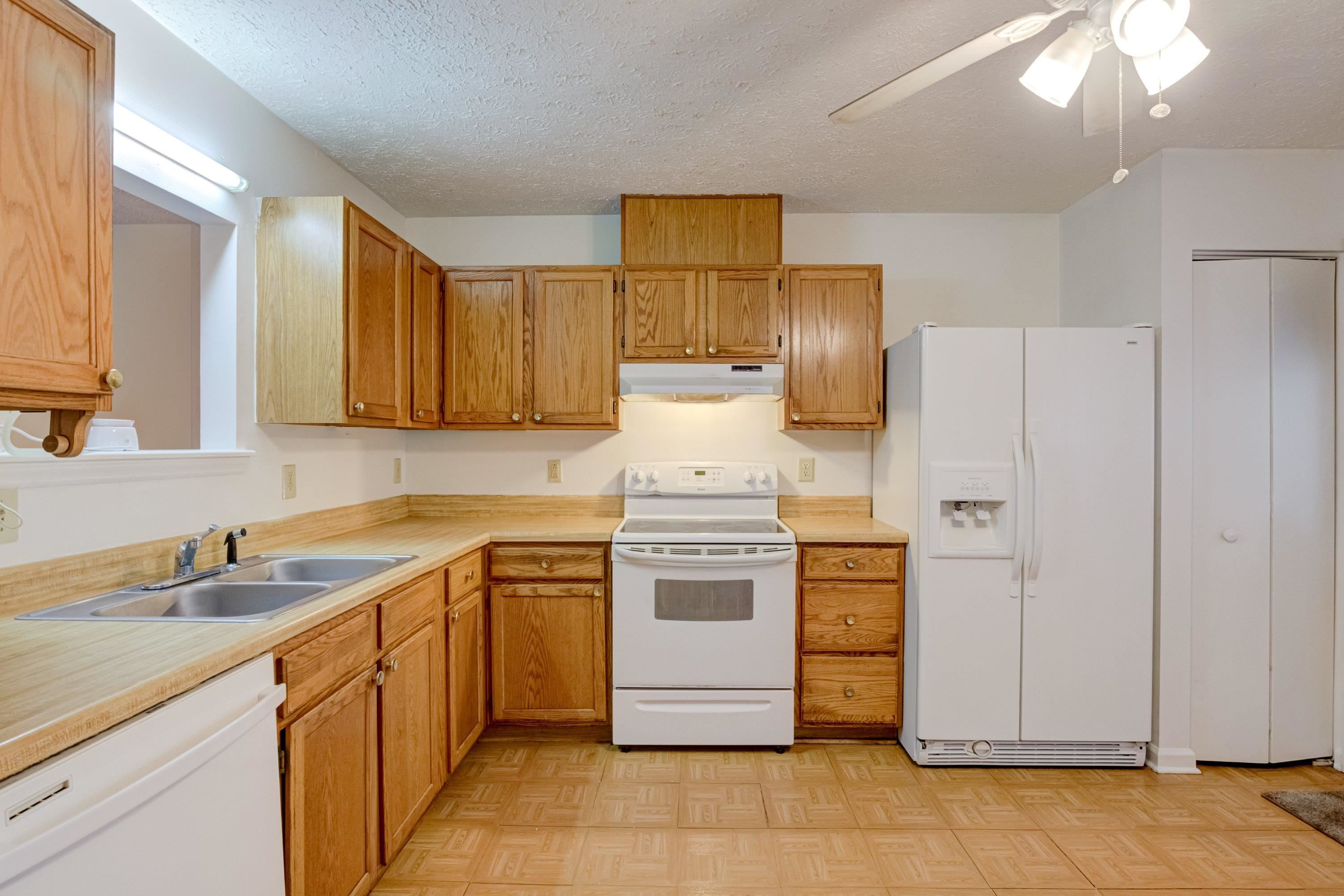 5823 Hadrian Drive Durham, NC 27703 - Photo 8 of 20 a kitchen with stainless steel appliances granite countertop a sink stove and refrigerator