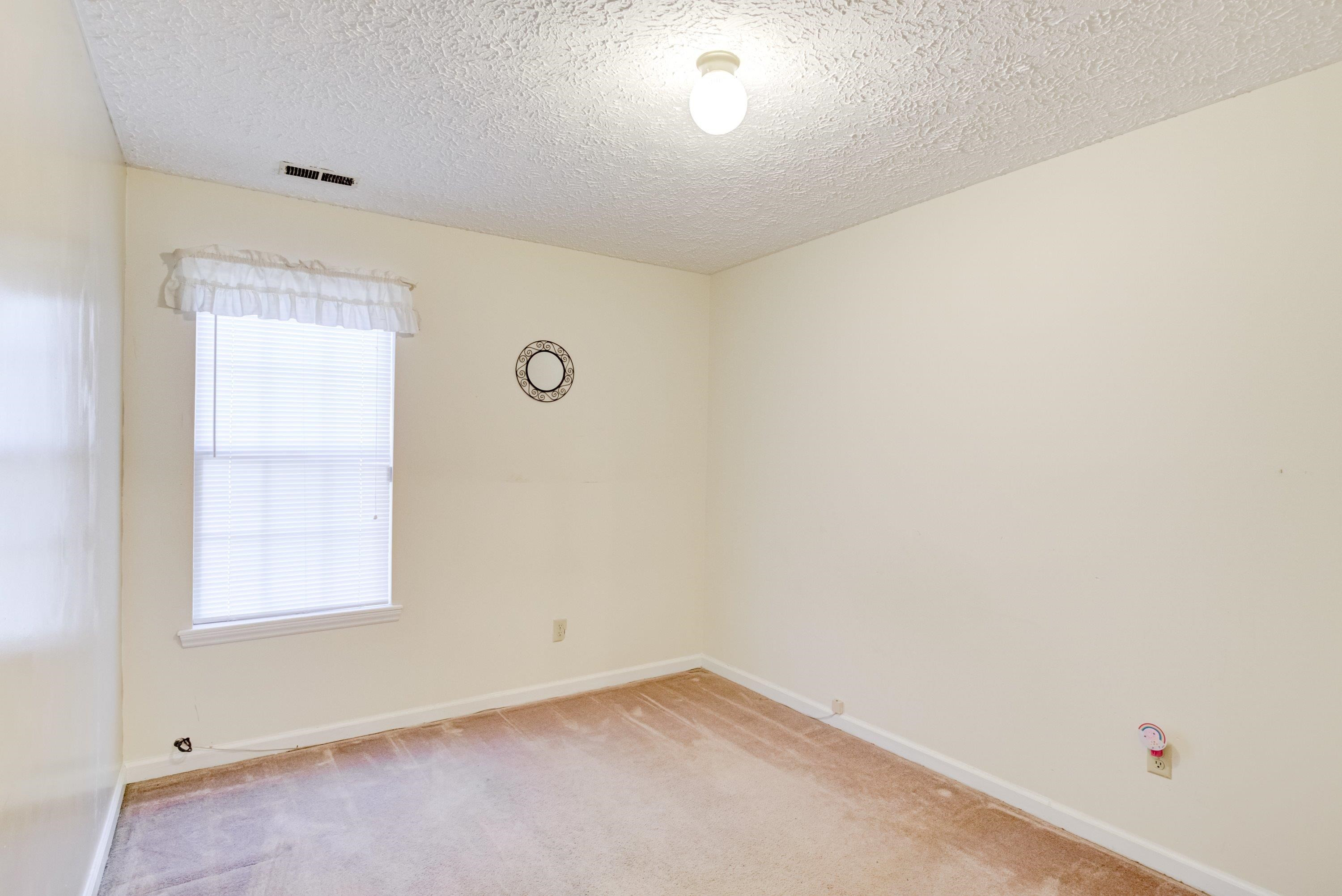 5823 Hadrian Drive Durham, NC 27703 - Photo 9 of 20 an empty room with a window