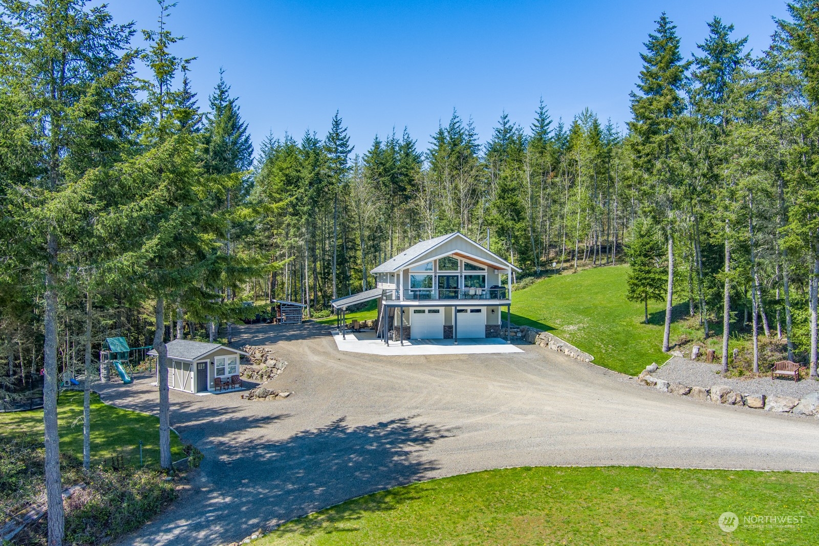 a front view of a house with a yard and trees