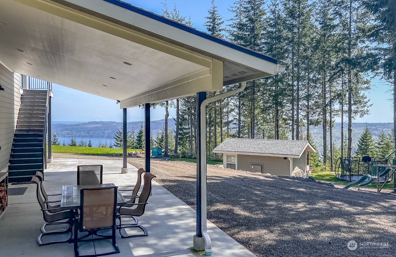 685 Misty Ridge Road Port Townsend, WA 98368 - Photo 12 of 39 a view of a patio with a table chairs and a backyard