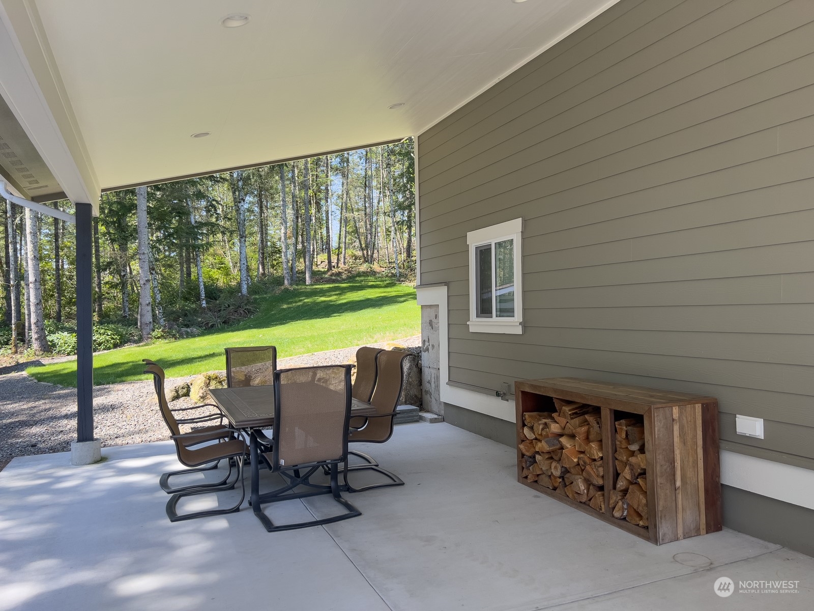 685 Misty Ridge Road Port Townsend, WA 98368 - Photo 15 of 39 a view of a patio with a table chairs and backyard