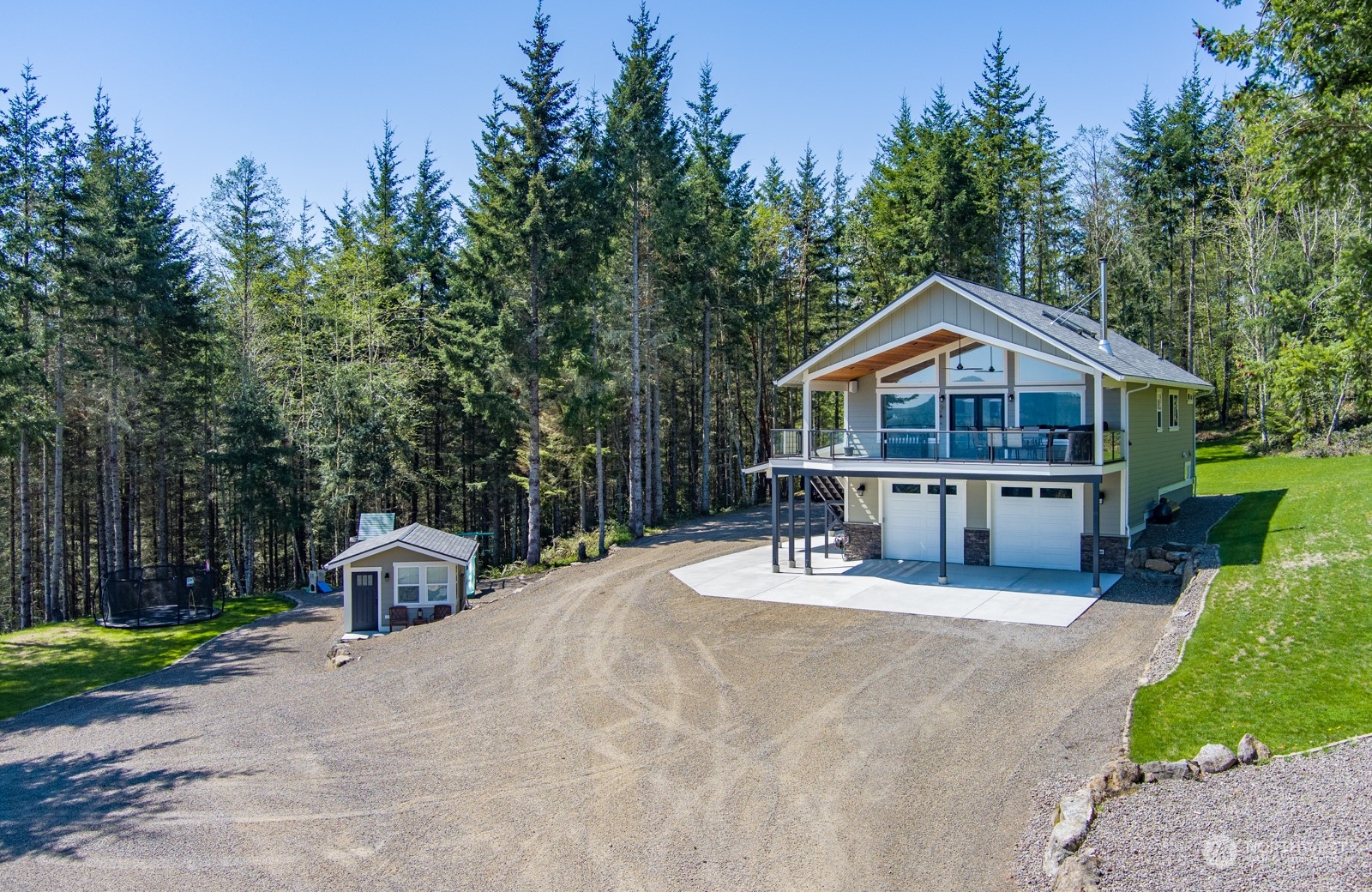 685 Misty Ridge Road Port Townsend, WA 98368 - Photo 2 of 39 a front view of a house with a yard and trees