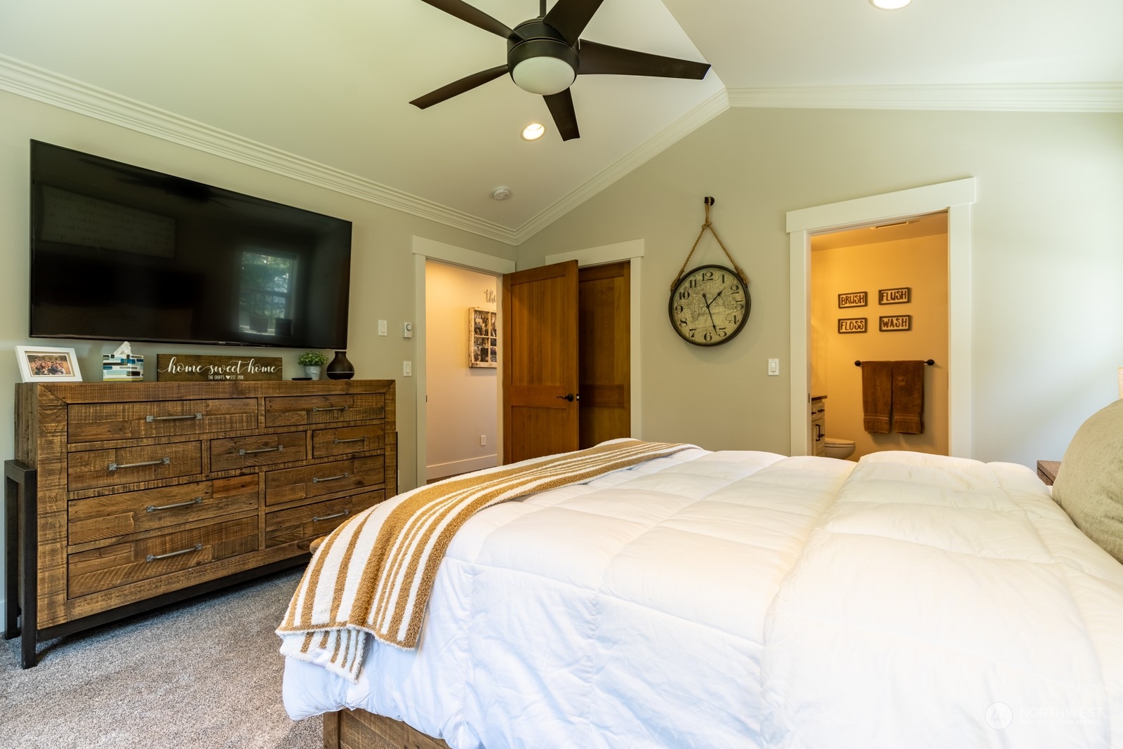 685 Misty Ridge Road Port Townsend, WA 98368 - Photo 27 of 39 a bedroom with a bed and a flat tv screen on dresser