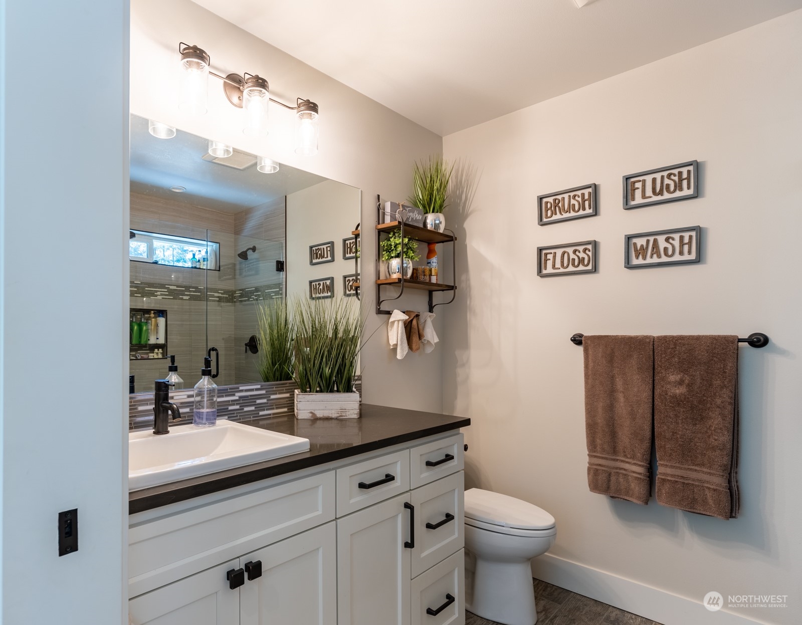 685 Misty Ridge Road Port Townsend, WA 98368 - Photo 28 of 39 a bathroom with a sink a toilet and mirror