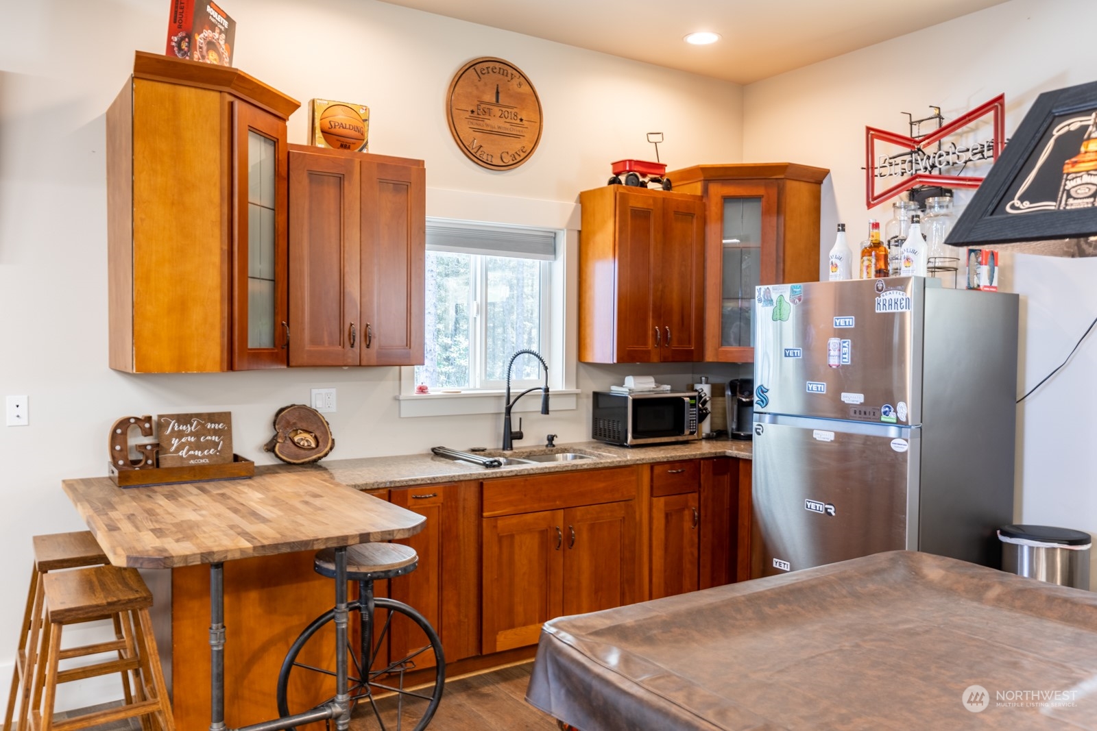 685 Misty Ridge Road Port Townsend, WA 98368 - Photo 36 of 39 a kitchen with stainless steel appliances granite countertop a sink a stove and a refrigerator with wooden floor