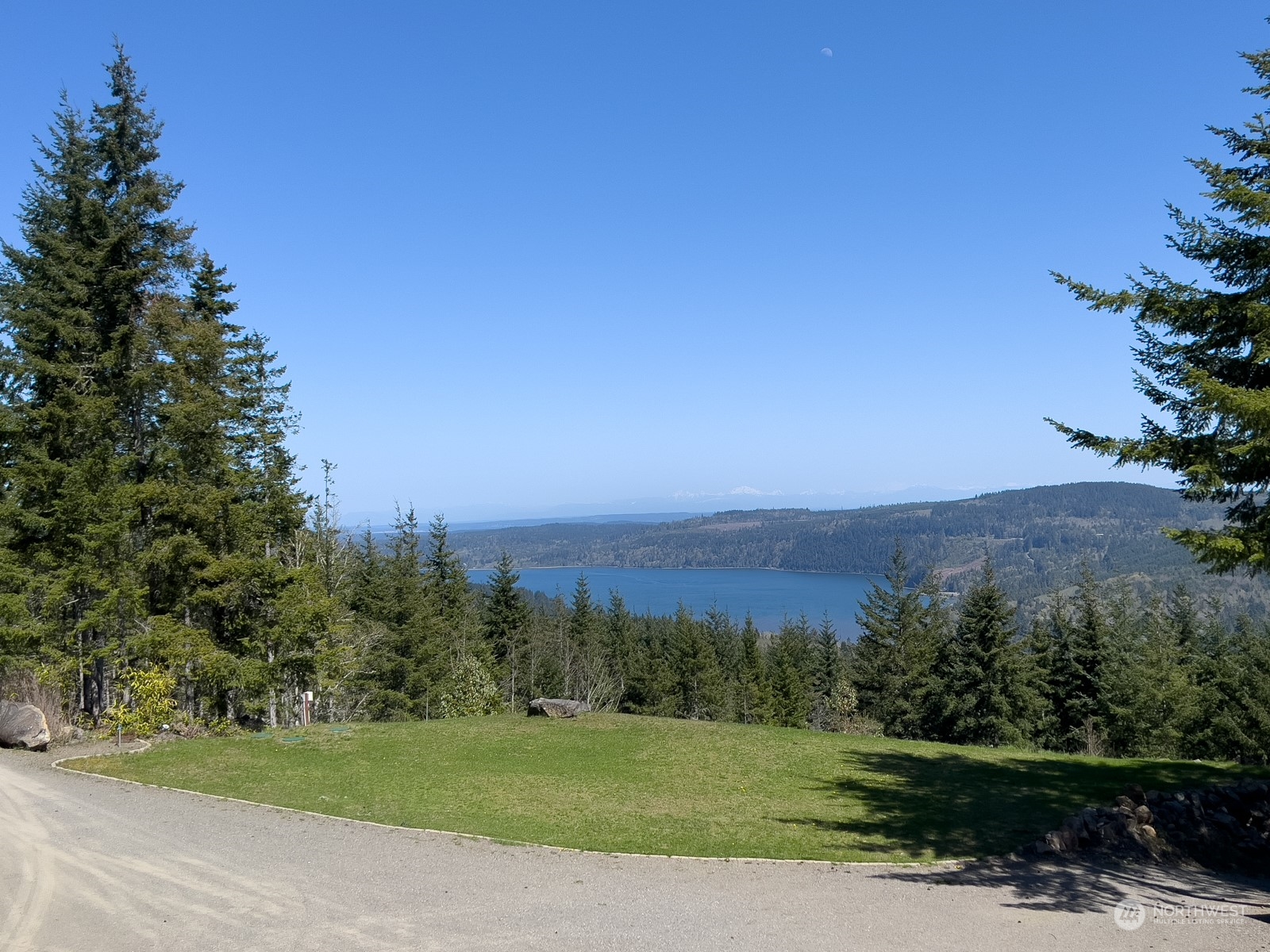 685 Misty Ridge Road Port Townsend, WA 98368 - Photo 6 of 39 a view of a grassy field with trees in the background