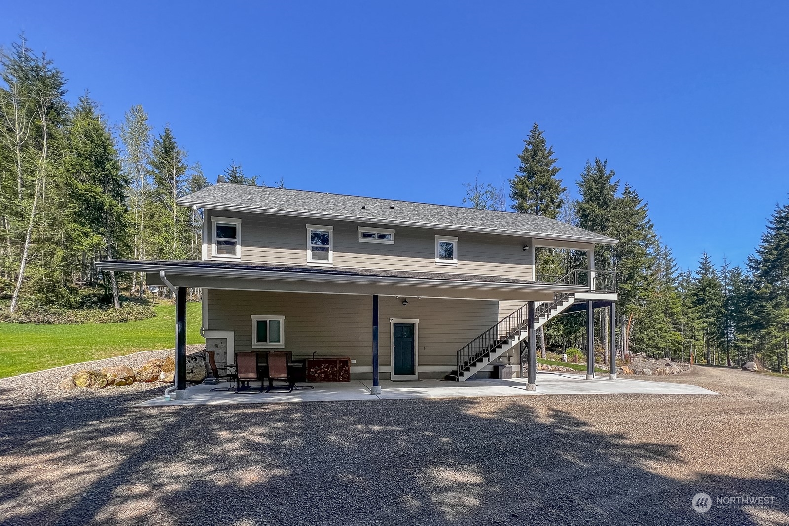 685 Misty Ridge Road Port Townsend, WA 98368 - Photo 10 of 39 a view of a house with a yard and garage