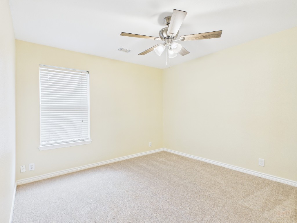 136 Winter Street Kyle, TX 78640 - Photo 13 of 32 an empty room with a window and a fan