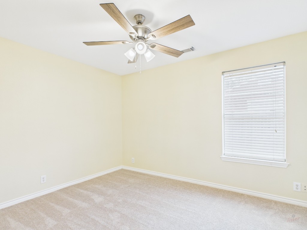 136 Winter Street Kyle, TX 78640 - Photo 14 of 32 an empty room with a window and a fan