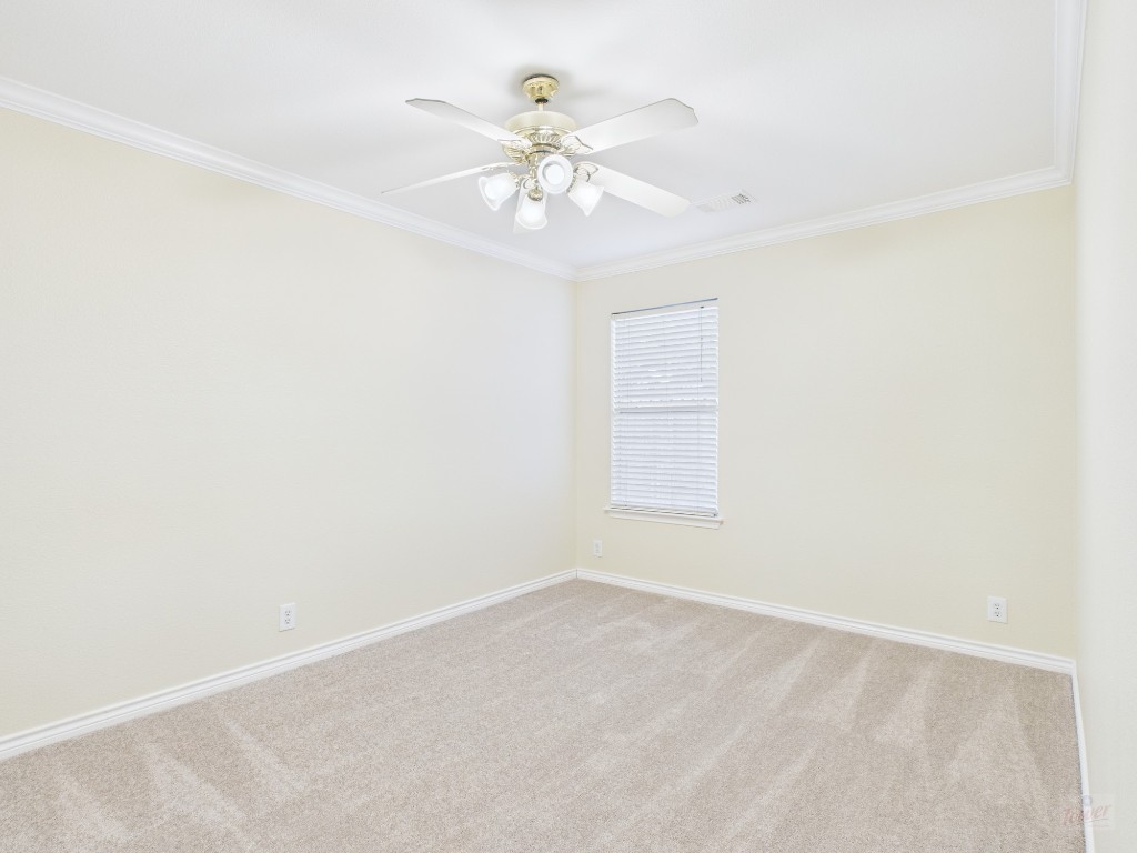 136 Winter Street Kyle, TX 78640 - Photo 18 of 32 an empty room with chandelier fan and windows
