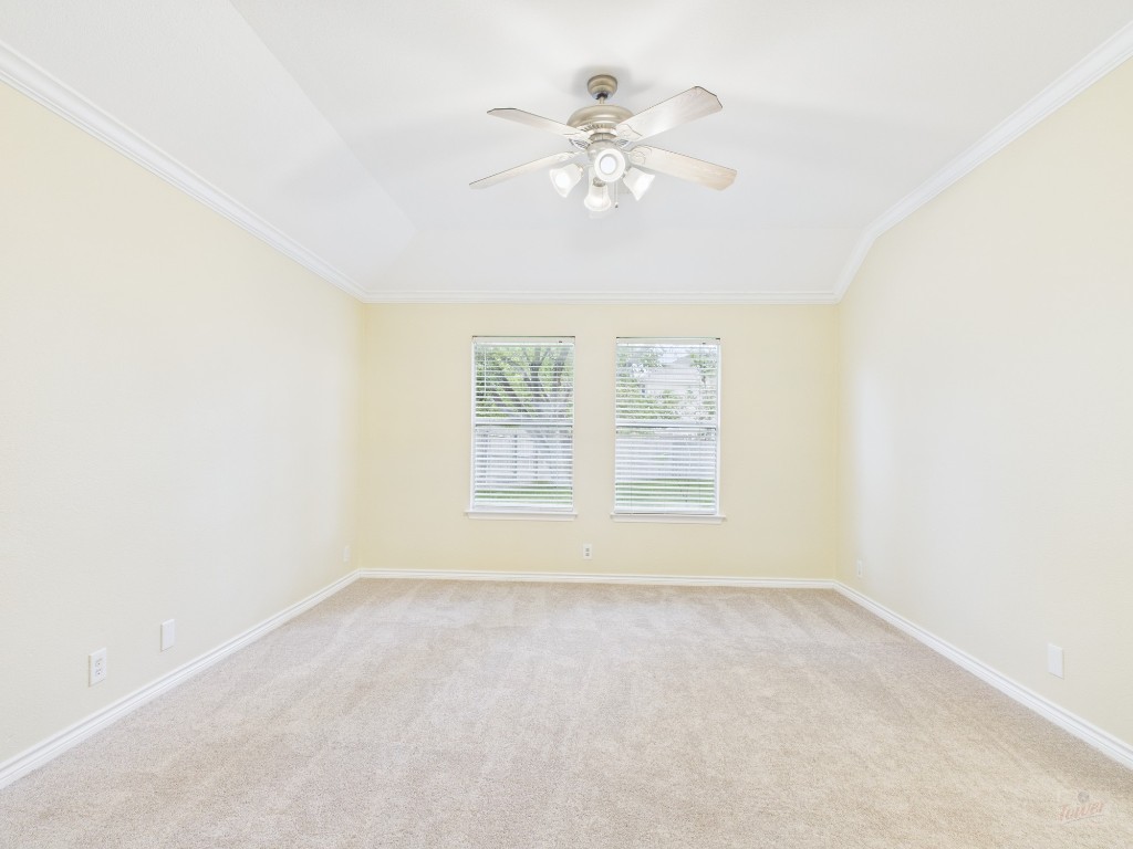136 Winter Street Kyle, TX 78640 - Photo 20 of 32 an empty room with a chandelier fan and windows