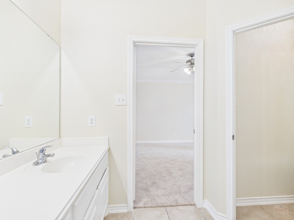 136 Winter Street Kyle, TX 78640 - Photo 22 of 32 a bathroom with a sink and a mirror
