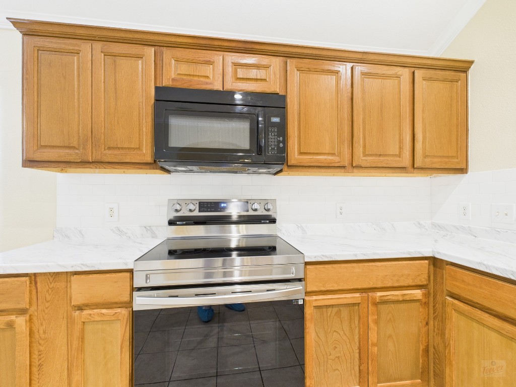 136 Winter Street Kyle, TX 78640 - Photo 9 of 32 a kitchen with granite countertop cabinets stainless steel appliances and a counter space