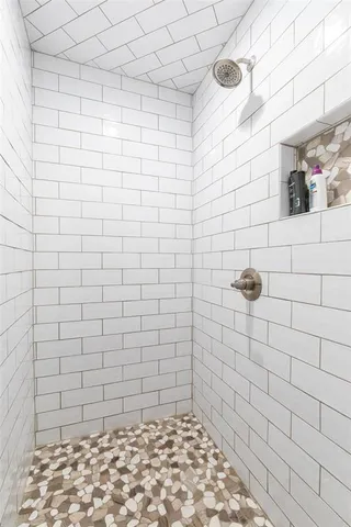 a bathroom with a bathtub and a shower