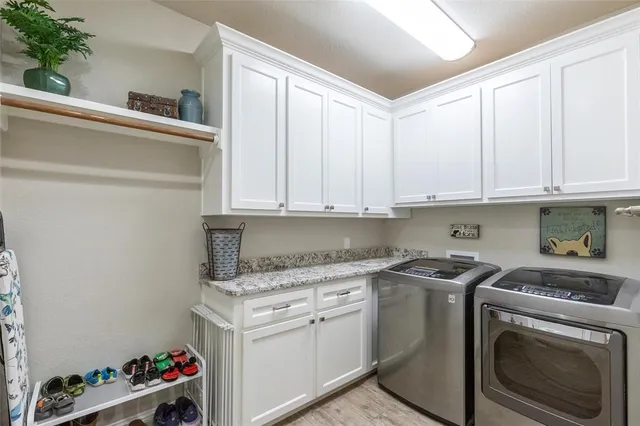 a kitchen with granite countertop white cabinets and a stove top oven