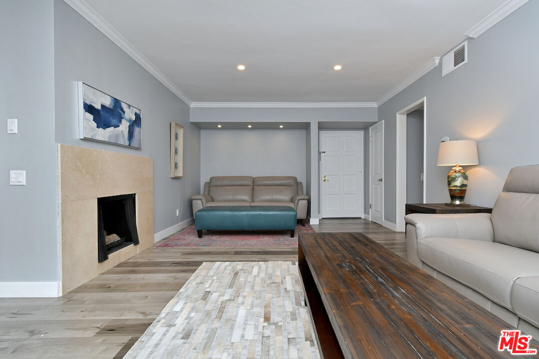 2345 Roscomare Road, Unit 205 Los Angeles, CA 90077 - Photo 11 of 50 a spacious bedroom with a bed and a fireplace